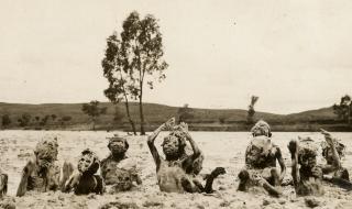 Children playing in wet sand in the Finke River c.1923