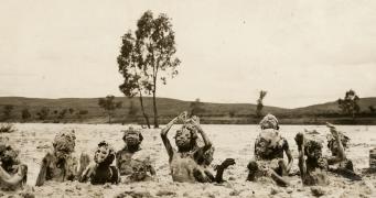 Children playing in wet sand in the Finke River c.1923