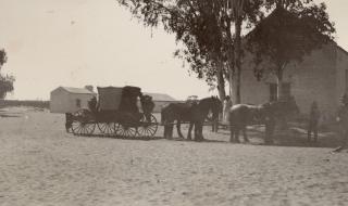 Horse drawn buggy in front of old church at Hermannnsburg.